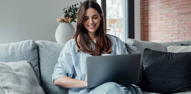 A woman on her laptop in her home.