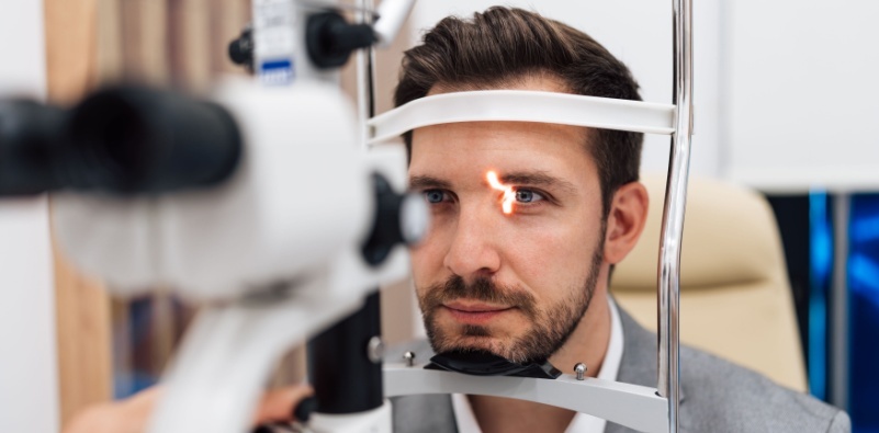 A man having an eye exam at the opticians.