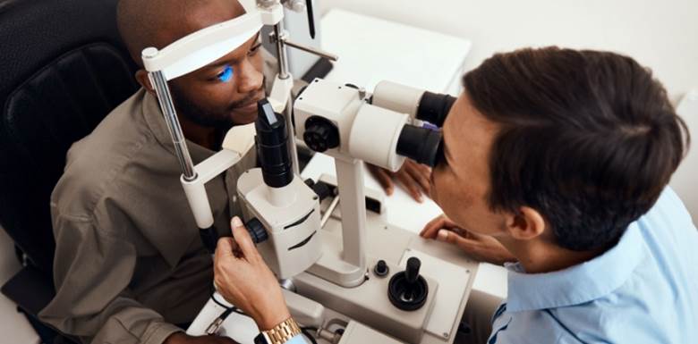 Testing and checking eyesight on an ophthalmoscope for optical glasses or contact lenses at opticians.