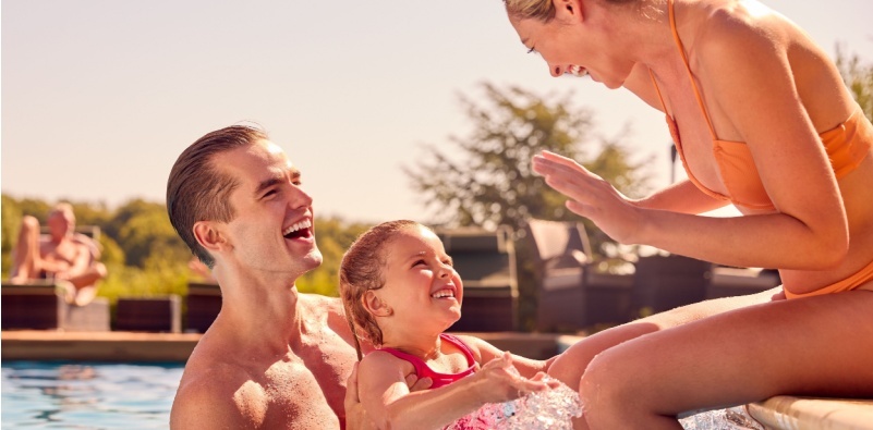 Smiling family in a swimming pool on holiday