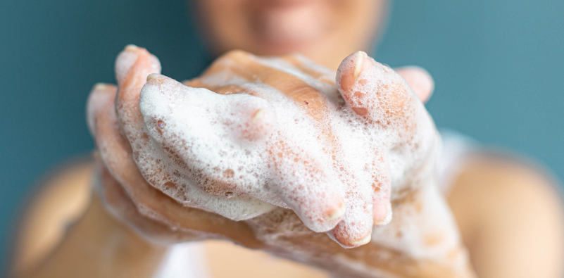 A close-up of a pair of soapy hands.