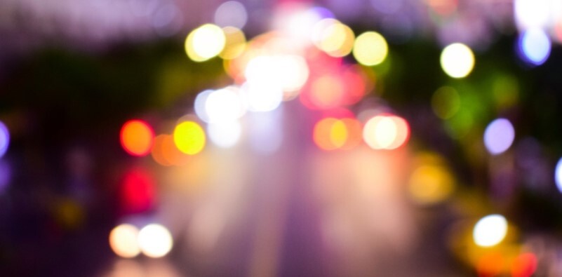 A visual representation of astigmatism showing blurred street lights and car headlights
