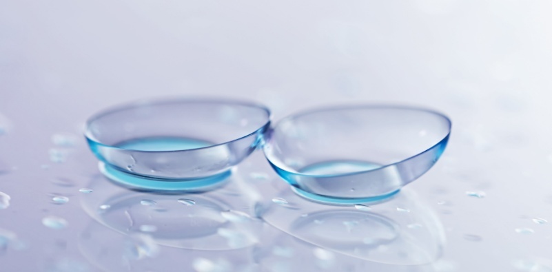 A pair of contact lenses on a clear surface