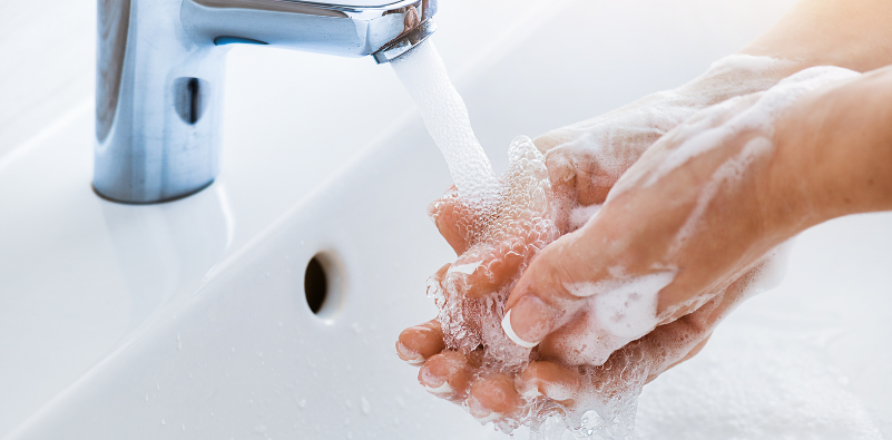 A person washing their hands with soap