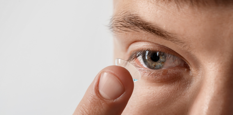 Man applying a contact lens to his eye